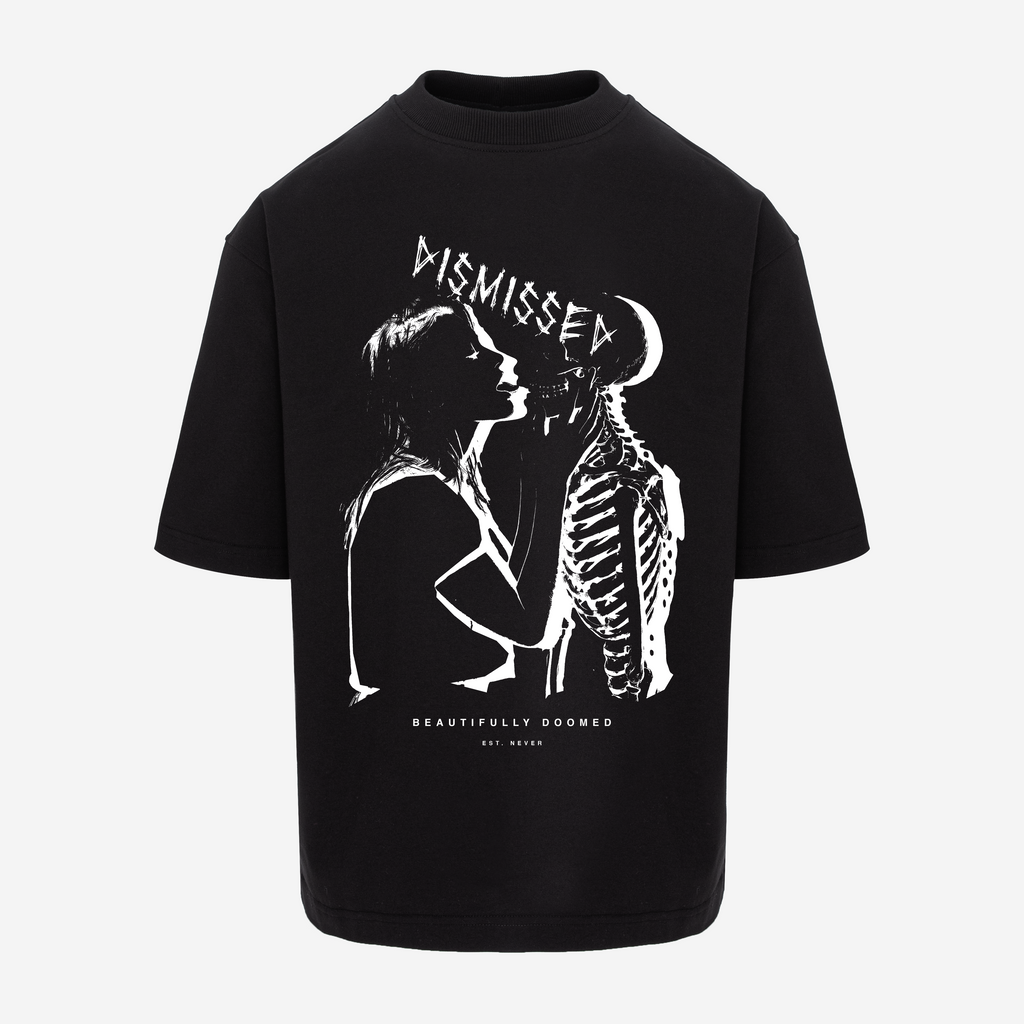 A black short-sleeve t-shirt with a white graphic print on the front showing a silhouette of a person next to a skeleton, with the text 'DISMISSED' and 'BEAUTIFULLY DOOMED' by 'ELI NEWMAN'.