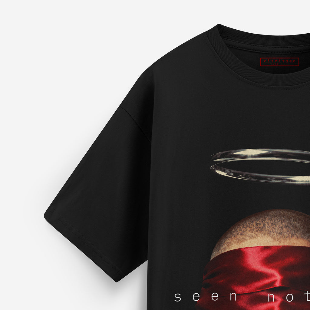Black t-shirt with a graphic design of a planet and red fabric, on a white background.